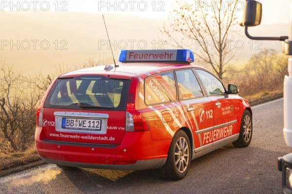 A red fire department car outside, rear view with sunset, fire brigade exercise on the Hermann Hesse railway, Ostelsheim, Germany