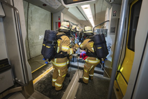 Firefighters board a train with special equipment in a rescue operation, fire brigade exercise on the Hermann Hesse railway, Ostelsheim, Germany