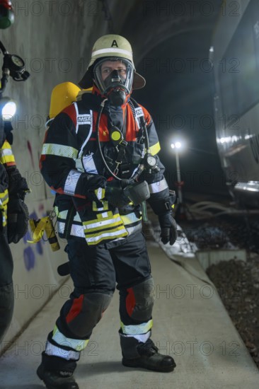 A firefighter in full protective clothing with respirator in the tunnel, fire department exercise on the Hermann Hesse Railway, Ostelsheim, Germany