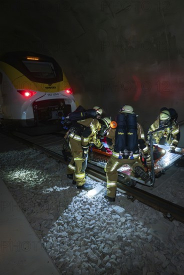 Firefighters carry out a rescue operation next to a train in a tunnel, fire brigade exercise on the Hermann Hesse railway, Ostelsheim, Germany