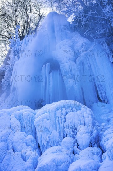Urach waterfall full of bizarre ice formations frozen at winter temperatures, Bad Urach, Swabian Jura, Baden-Württemberg, Germany