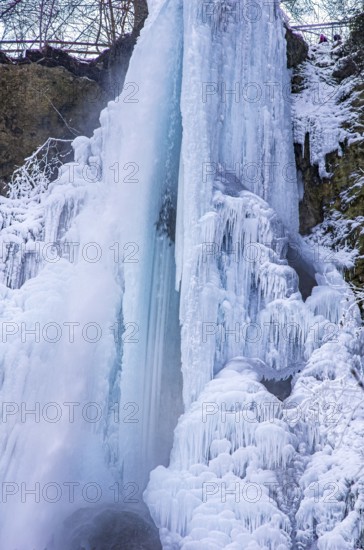 Urach waterfall full of bizarre ice formations frozen at winter temperatures, Bad Urach, Swabian Jura, Baden-Württemberg, Germany