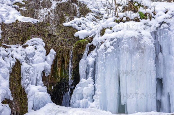 Urach waterfall full of bizarre ice formations frozen at winter temperatures, Bad Urach, Swabian Jura, Baden-Württemberg, Germany
