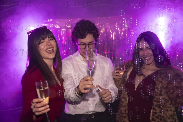 Friends cheering and having fun while celebrating a party with champagne and bubbles, experiencing joy and happiness in a vibrant night club atmosphere with purple lighting
