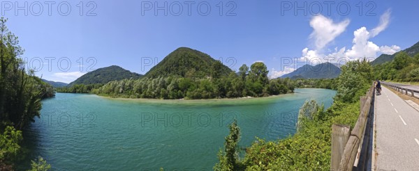 Panoramic view of lake with surrounding mountains and road on the edge, Slovenia