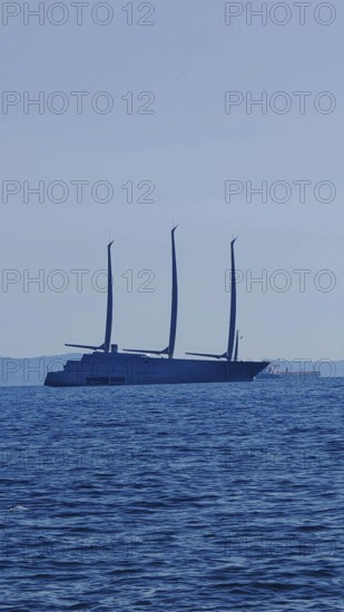 Large modern sailing ship Sailing yacht a, largest sailing yacht in the world, with three masts on the open sea on the horizon, Trieste, Italy