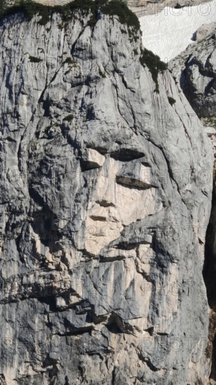Natural formation of a face in a rock wall, Slovenia