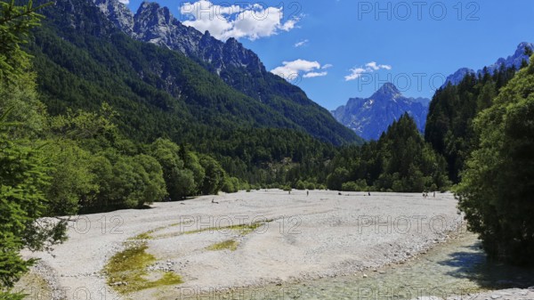 Wide valley with mountains and riverbed in the foreground, Slovenia
