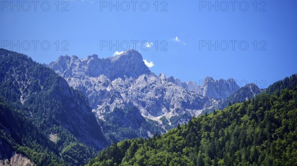 Mountain massif with rocky peaks and forest, Slovenia