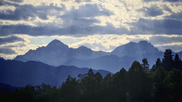 Mountain landscape with silhouettes and clouds in the sky, Slovenia