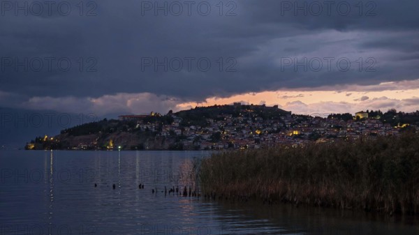 Night scene of an illuminated lake with a city in the background, Lake Ohrid, North Macedonia