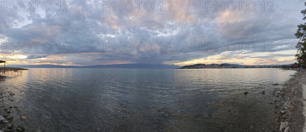 Panoramic view of a lake at sunset with dramatic clouds in the sky, Lake Ohrid, North Macedonia