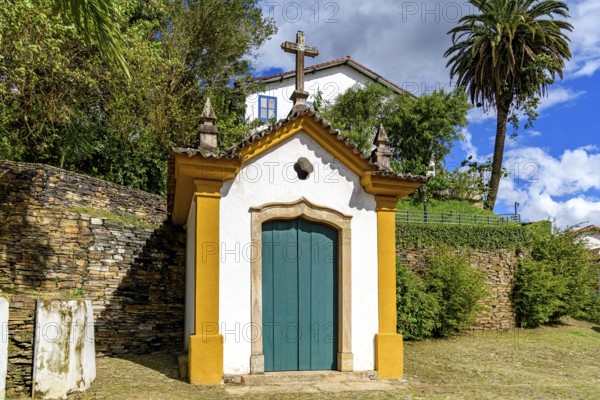 Historic 18th century chapel with a stone crucifix. Passo da Ponte Seca in the city of Ouro Preto