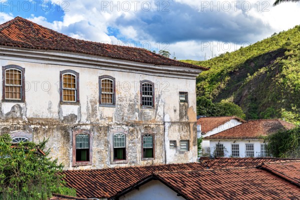Facade of a historic colonial mansion deteriorated by time in the city of Ouro Preto in Minas Gerais, Ouro Preto, Minas Gerais, Brazil