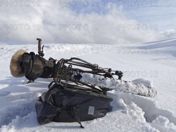 A bicycle is lying in the snow in a cold winter landscape, Upper Franconia, Germany