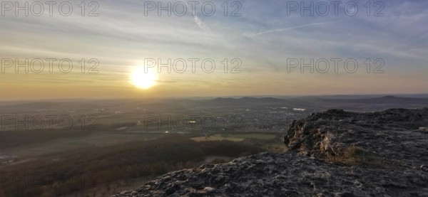 Breathtaking sunset over a vast landscape seen from a rocky outcrop, Staffelberg, Upper Franconia