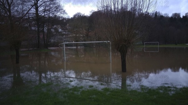 Football field is under water, surrounded by trees, snow melt high water, Kronach, Upper Franconia