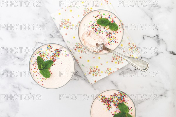 Fruit mousse, made from jelly and cottage cheese, in glasses, decorated with sprinkles and mint, homemade