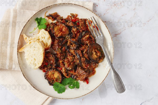 Stewed meat with eggplant is a Georgian dish, on a light background, homemade, no people