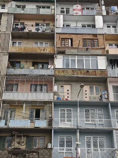 An urban high-rise building with various colorful balconies showing different areas of life, Tbilisi, Georgia