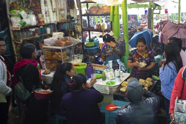 Mayan woman in traditional clothing preparing food, market in Sololá, Highlands, Sololá Department, Guatemala