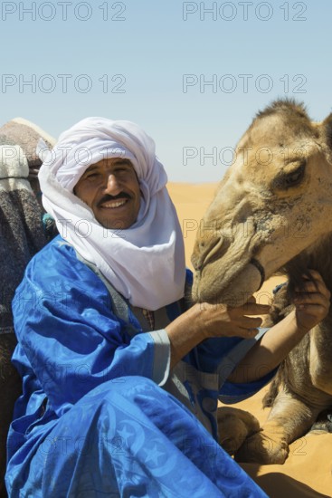 Berbers and dromedaries in the sand dunes, near Merzouga, Meknès-Tafilalet region, Erg Chebbi, northern Sahara, Morocco
