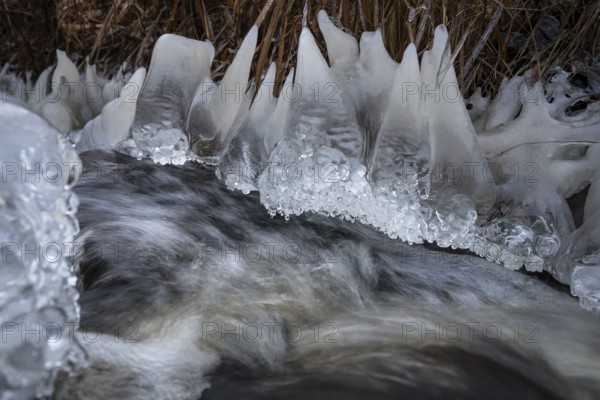 Teeth-like ice sculptures on the banks of a fast-flowing stream, winter, near Heinola, Finland