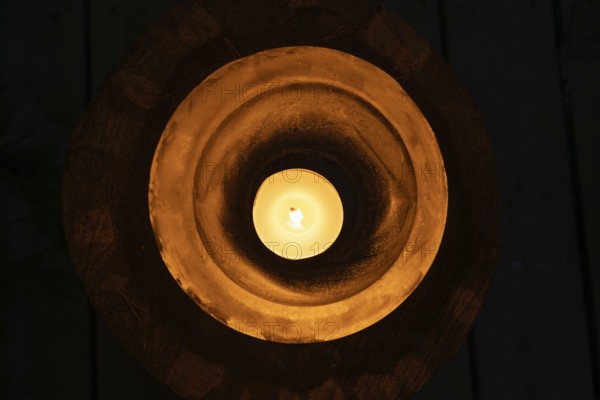 Ice bowl illuminated by a burning tea light, winter, Finland