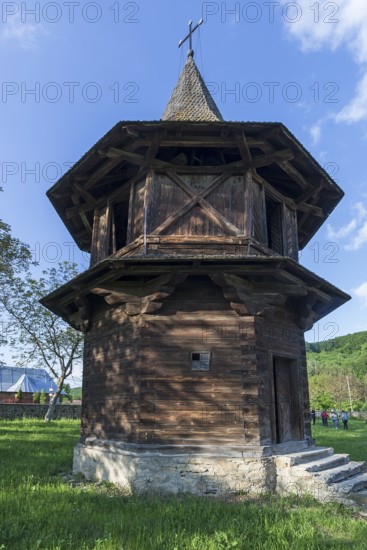 Wooden bell tower near the Church of the Exaltation of the Cross, Patrauti Moldavian monastery from the 15th century, Patrauti, Romania
