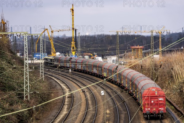 Freight train on the railway line at the Duisburg-Kaiserberg motorway junction, constricted lanes, heavy traffic, complete conversion and construction of the A3 and A40 intersections, all bridges, ramps, roadways are renewed and partly extended, 8-year construction period, railway bridges running there will also be renewed, North Rhine-Westphalia, Germany