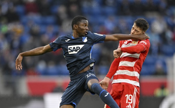 Foul, punch in the face, head-to-head duel action Bazoumana Toure TSG 1899 Hoffenheim (29) v Janik Haberer 1. FC Union Berlin FCU (19) Football, Bundesliga, PreZero Arena, Sinsheim, Baden-Württemberg, Germany