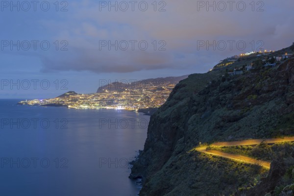 View of the Atlantic Ocean from Christo Rei viewpoint at dusk, harbour with cruise ships and Funchal, Madeira, Portugal
