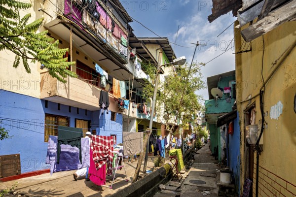 Colourful narrow neighborhood alleyway with clotheslines and a homely atmosphere
