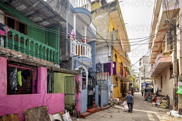 Colourful residential buildings on a busy urban street with passers-by