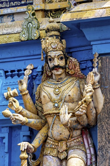 Detailed and colorful sculpture of a deity at a temple