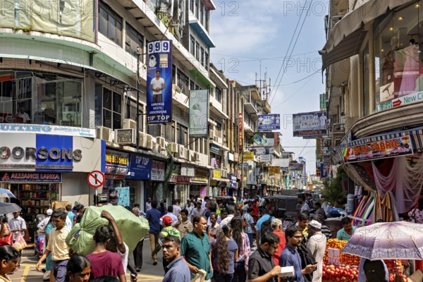 Bustling street scene with lots of people and shops under blue skies, the hustle and bustle of Colombo city center in Sri Lanka