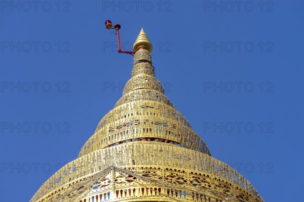 Umbrella over the Buddha statue in Wat Intharawihan, a ceremonial, often multi-level symbol of protection and sanctuary, Wat Intharawihan, the temple was built at the beginning of the Ayutthaya period, Bangkok, Thailand