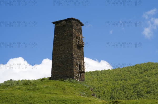 Single old tower on hill with green landscape and cloudy sky, Queen Tamar's tower, Tamara, Ushguli, Ushguli, Chazhashi district, Upper Svaneti, Svaneti, Georgia