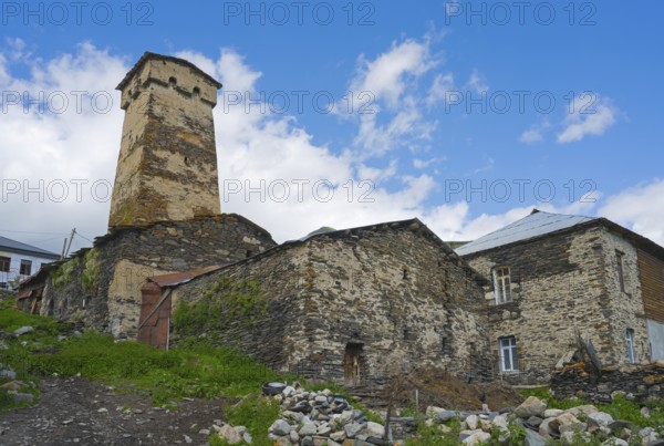 Old stone ruin with defence tower against a cloudy sky, defensive tower, Ushguli, Shibiani district, Zhibiani, Upper Svaneti, Svaneti, Georgia