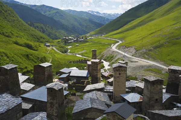 Village with several towers and a road in lush mountain scenery, defensive towers, Ushguli, Ushguli, Chazhashi district, Mingrelia region and Upper Svaneti, Svaneti, Georgia