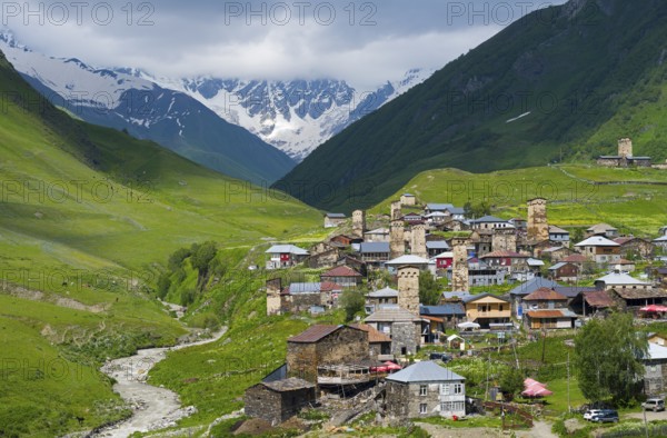 Mountain village with numerous towers and a river, surrounded by green hills, defensive towers, Ushguli, Ushguli, Shibiani district, Zhibiani, Enguri river, Mingrelia region and Upper Svaneti, Svaneti, Georgia
