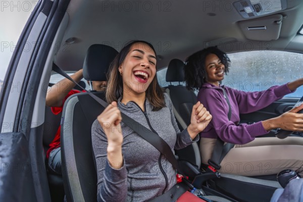 Young diverse friends singing and laughing together in a car on a road trip, sharing joyful moments, bonding and enjoying a sunny journey of adventure and freedom