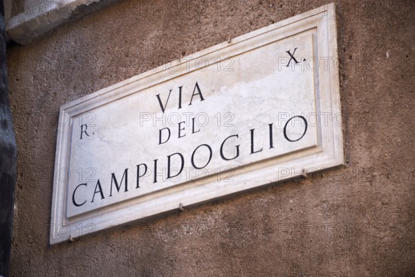 Stone road sign with the inscription 'Via del Campidoglio' on an ancient wall, Capitol Square, Rome, Lazio, Italy