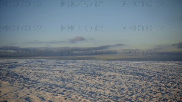 Snow-covered landscape under clear sky at twilight, Rennsteig