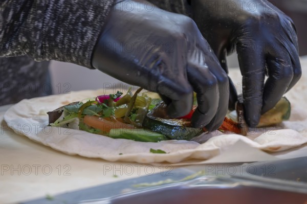 Preparation of falafel with vegetables at a falafel stand in the pedestrian zone, Nuremberg, Middle Franconia, Bavaria, Germany