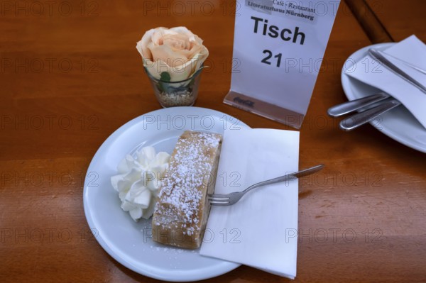 Apple strudel served with cream in a café, Nuremberg, Middle Franconia, Bavaria, Germany