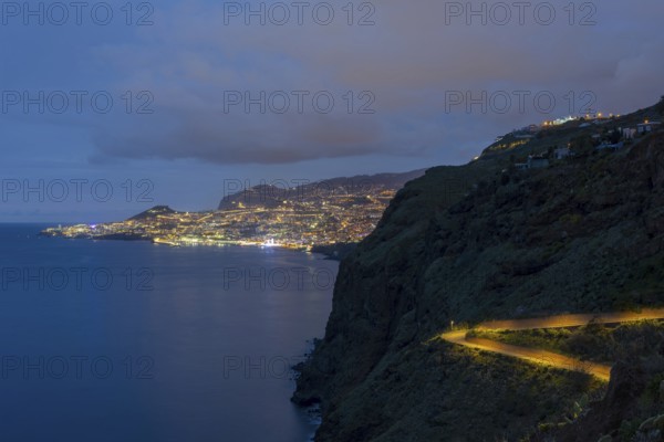 View of the Atlantic Ocean from Christo Rei viewpoint at dusk, harbour with cruise ships and Funchal, Madeira, Portugal