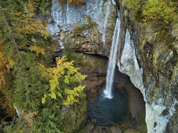 Aerial view of Berglistüber waterfall in autumn-colored surroundings, Linthal, Klausenpass, Canton of Glarus, Switzerland