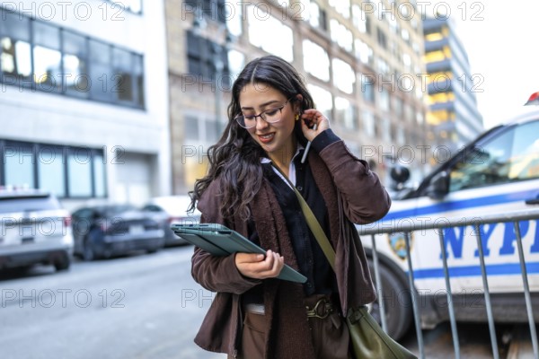 Young businesswoman in glasses walking manhattan streets, focused on her digital tablet while working remotelyconfident, mobile professional blending city life and productivity