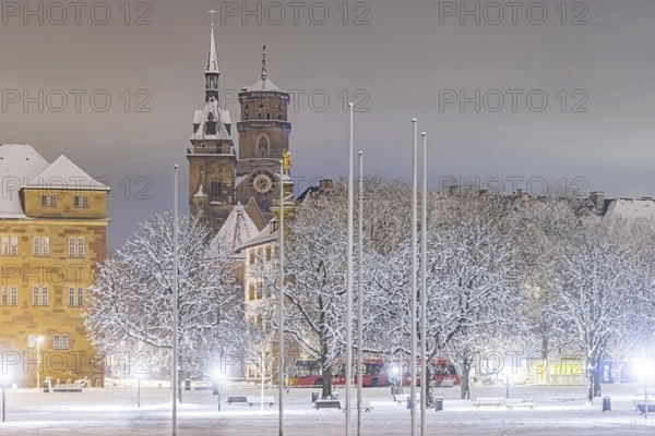 Winter in Stuttgart. The city is wintry white early in the morning. Castle square with collegiate church. Stuttgart, Baden-Württemberg, Germany